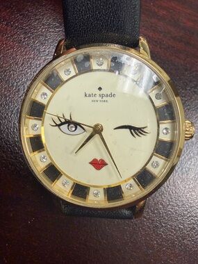 kate spade Ivory, Black & Gold Winking Face Watch with Red Accent